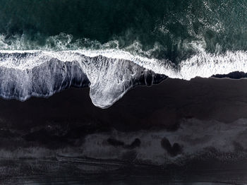Aerial view of the iceland coastline by the black beach.