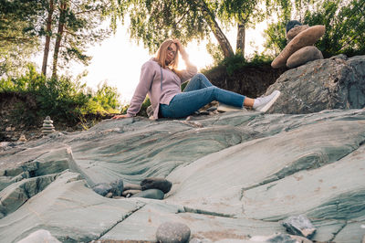 Woman sitting on rock