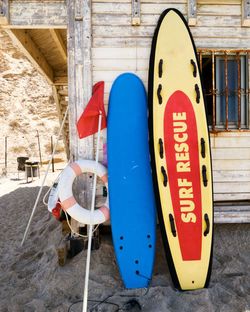 Close-up of text on surfboard at beach