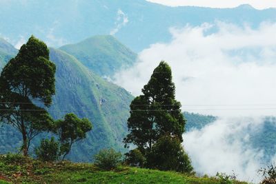 Scenic view of mountains against cloudy sky