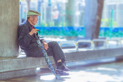 Side view of man looking at camera