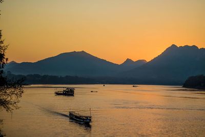 Scenic view of silhouette mountains against sky during sunset