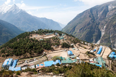 High angle view of townscape and mountains against sky