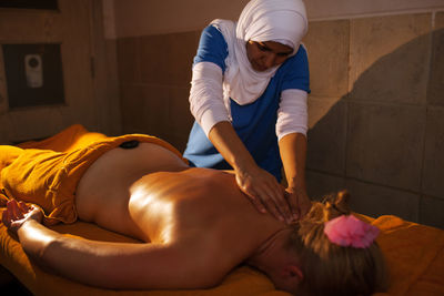 Woman receiving lastone therapy at spa