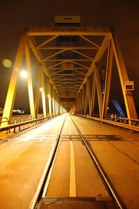 Surface level of illuminated bridge against sky at night