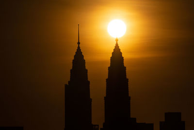 Low angle view of silhouette building against sky during sunset