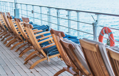 Empty chairs and tables in swimming pool