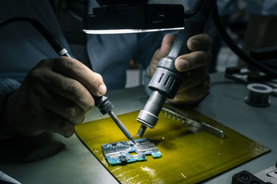 Close-up of man working on machine