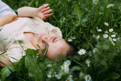 Midsection of woman lying on field