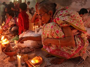 Lighting candle at rakher upobash barodi lokhnath brahmachari ashram