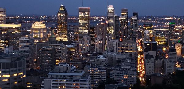 Aerial view of illuminated buildings in city at night