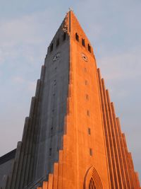 Low angle view of orange temple against sky