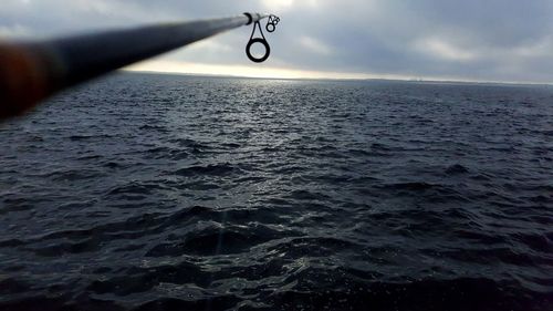 Close-up of water drops on sea against sky