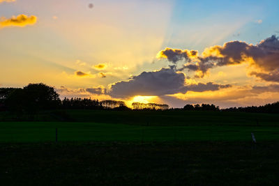 Scenic view of field against sky during sunset