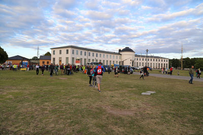 Group of people in front of building against sky