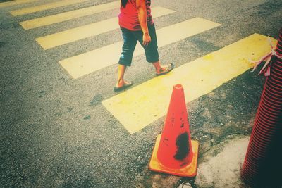 Low section of child standing on road