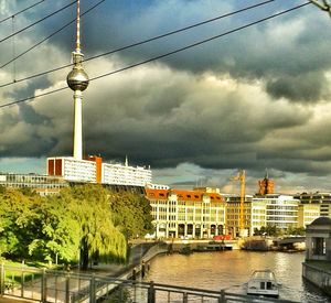 Buildings against cloudy sky