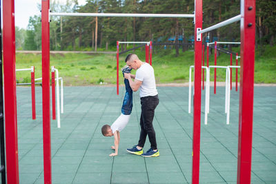 Full length side view of a man playing soccer