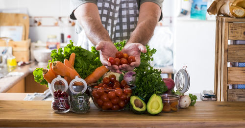 Midsection of vegetables on table at home