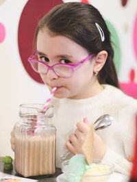Portrait of a beautiful one child girl drinking a chocolate drink.