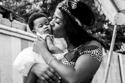 Close-up of mother kissing daughter