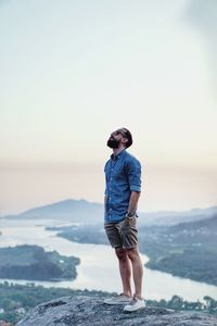 Full length of man standing on sea against sky