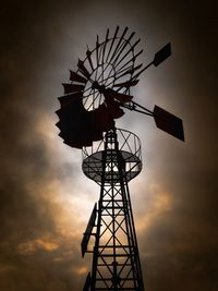 Low angle view of silhouette windmill against sky during sunset