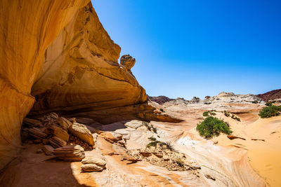 Rock formations in desert against clear blue sky