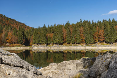 Upper lake of fusine, tarvisio. autumnal fire reflections. at the foot of the mangart