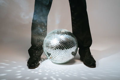 Low section of person holding crystal ball