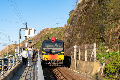 Train on railroad track against sky