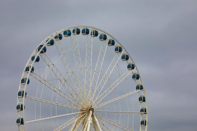 Low angle view of ferris wheel against sky