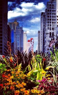 Buildings in city against cloudy sky