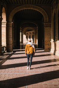 Rear view of man standing at historical building