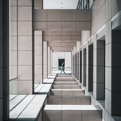 Side view of man walking in corridor