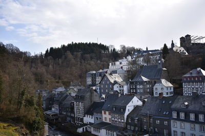 High angle view of buildings in town against sky