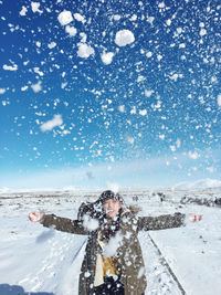 Person on snow covered landscape against sky