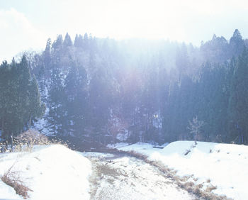 Scenic view of snow covered mountains against sky
