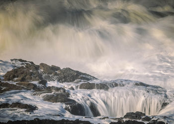 Scenic view of waterfall against sky