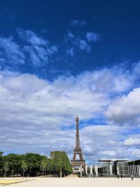 Tower of building against cloudy sky