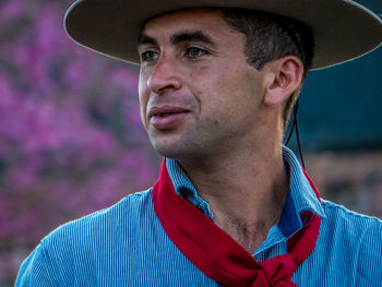 Man wearing hat standing outdoors