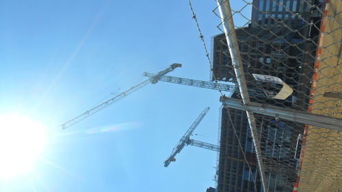 Low angle view of crane against sky