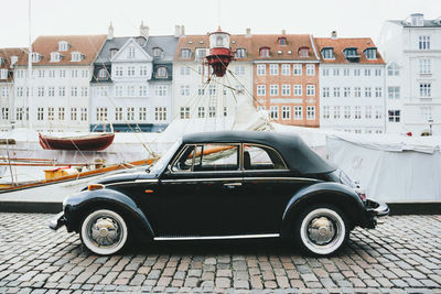 Vintage car on bridge in city