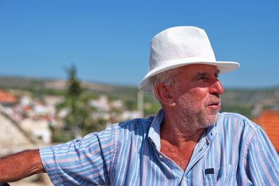 Portrait of man wearing hat against sky