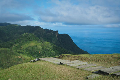 Scenic view of sea and mountains against sky