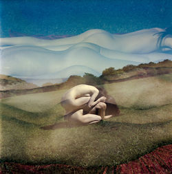 Digital composite image of woman hand on landscape