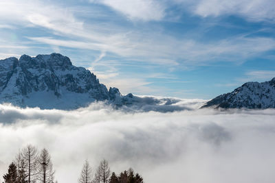 Amazing scenic view of clouds under snow capped mount on s sunny winter day