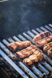 High angle view of meat on barbecue grill