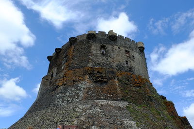 Low angle view of old tower against sky