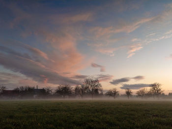 Scenic view of field against sky during sunset